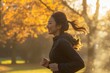© blvdone - Woman running jogging in a park in the morning