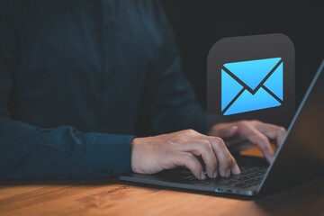 Poster - Hands typing on a laptop keyboard with a glowing email icon above, symbolizing digital communication, online messaging, or professional email services.
