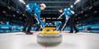 © hobonski - Close-up shot of a curling stone with a bright yellow handle in focus, placed on the ice. A team of four curlers is blurred in the background, engaged in their strategic game.