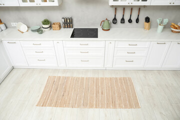 Canvas Print - Stylish soft rug on wooden floor in kitchen