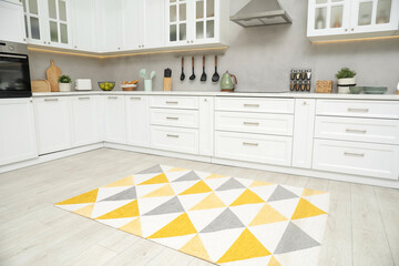 Canvas Print - Stylish soft rug on wooden floor in kitchen