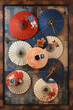 © Lume Origin Visuals - Decorative Composition of Traditional Japanese Umbrellas in a Colorful Arrangement against a Rustic Wooden Background