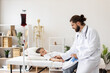 © sofiko14 - Male doctor assists young Caucasian girl receiving blood transfusion at medical facility. Scene captures essence of care and empathy in healthcare setting, highlighting doctor-patient professionalism.