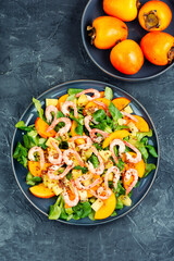 Wall Mural - Seafood shrimp persimmon salad on white plate.