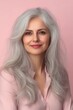 © Ilja - Portrait of a Beautiful Senior Woman with Gray Hair, Smiling on a Pastel Background, with Copy Space