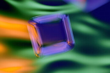 Poster - Floating Green Glass Cube with Vibrant Abstract Background