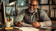 © standret - Smiling male tax advisor working in a modern office setting