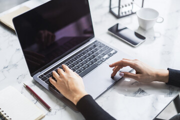 Poster - Picture shows a woman's hands in close detail, typing on a contemporary laptop keyboard, with a softly blurred office setting in the backdrop