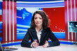 © DC Studio - Woman reporter presents news bulletin live on television channel worldwide, reading latest headlines and creating global content. Media presenter talks about daily occurences, advertisement.
