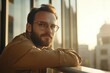 © Oleksandr - Young Man Leaning on Railing at Office Building, Bathed in Sunlight