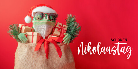 Wall Mural - schönen nikolaustag grußkarte mit deutschem text - süßes chamäleon mit nikolausmütze, sonnenbrille u