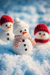Aufkleber - Three colorful knitted snowmen stand together in a snowy scene