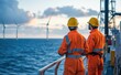 © Surachetsh - Two engineers in protective gear monitor offshore wind turbines, reflecting the high-level skills and commitment essential for marine environment maintenance.
