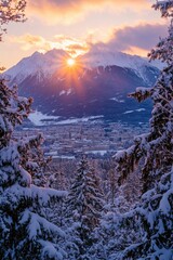 Aufkleber - A serene landscape of snow-capped mountains at sunset, with a warm glow and gentle shadows