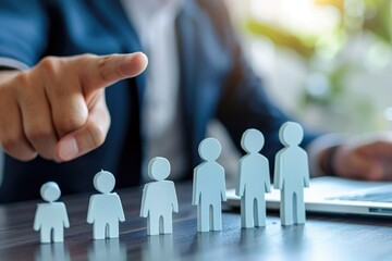 Poster - A person points to a group of paper cutouts, potentially used for presentation or visual aid