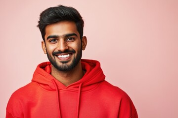 Aufkleber - A person wearing a bright red hoodie and smiling directly at the camera