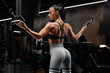 © nikolas_jkd - Fitness woman working out in gym doing exercise for back. Athletic girl