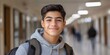 © Masque - A smiling Hispanic teenager showcases the dedication to learning in a school corridor.