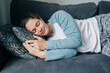 © Ilona - Sleeping woman taking nap on the sofa during the day