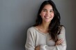© Anjali - Portrait of young Latin woman with crossed arms and smile.