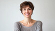 © Atmospheric stock - Smiling caucasian young adult female with short hair in gray sweater