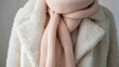 © Atmospheric stock - Cozy winter outfit with beige knit scarf and white fleece jacket