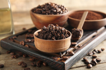 Composition with cutting board and coffee body scrub in bowl on wooden background, closeup