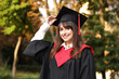 © New Africa - Graduation ceremony. Happy student in academic dress outdoors