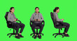 © DC Studio - Young adult enjoys videogames against full body greenscreen backdrop, sitting on chair and using joystick on online gaming tournament. Cheerful modern man having fun with rpg gameplay.