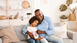 © Prostock-studio - Stay at home concept. African American family of granddad and granddaughter embracing indoors. Panorama
