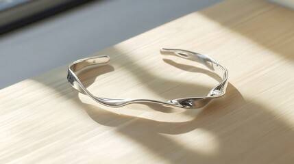 Poster - elegant and sleek metallic curved sculpture or accessory displayed in a minimalist studio setting wi