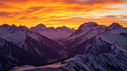 Wall Mural - vibrant sunset over majestic mountains with gold and orange hues reflecting off the snow-covered pea