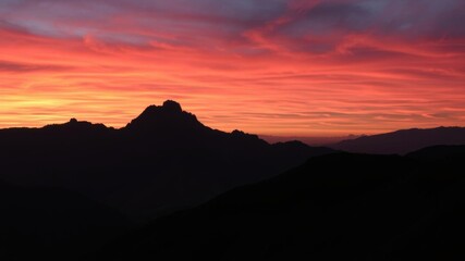 Wall Mural - vibrant orange and pink hues paint the sky above rugged mountains during sunset, scenic, serene