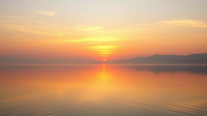 Wall Mural - a serene image of a lake reflecting the warm hues of the setting sun, creating a tranquil atmosphere