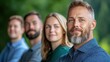 © maesarin - A group of smiling happy adults of different ages and backgrounds standing together in a lush green outdoor setting such as a garden or forest suggesting a sense of community friendship