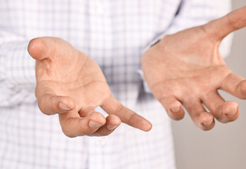 Wall Mural - man holding something on grey background, closeup