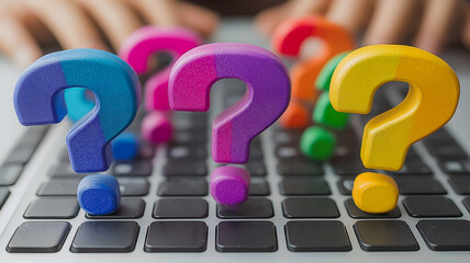 Poster - A keyboard with three colorful questions on it. The questions are in different colors and are placed in different positions on the keyboard. Concept of curiosity and learning