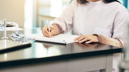 Poster - Woman, scientist or hands writing with book for research, study or labratory results on desk. Japan, closeup or medical worker with notes, exam or test for experiment, development or discovery at lab
