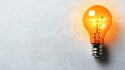 Poster - Vintage Style Light Bulb Illuminating a Textured White Wall with Soft Orange Glow, Capturing a Warm and Nostalgic Atmosphere for Decor and Interior Design