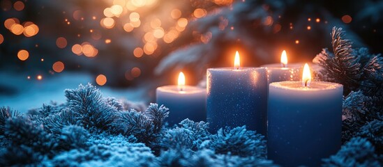 Poster - Lit white and blue candles surrounded by frosted foliage against a shimmering bokeh backdrop creating a warm inviting atmosphere
