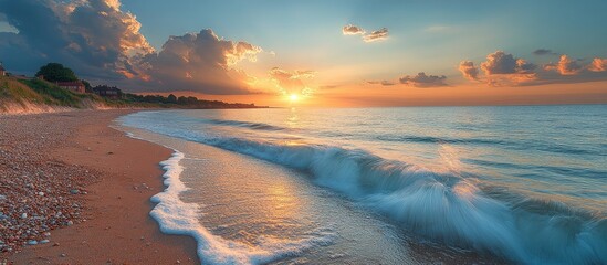 Aufkleber - Serene sunset over a tranquil beach with gentle waves and vibrant clouds reflecting on the water surface.