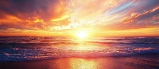 Poster - Vibrant sunset over tranquil tropical beach with colorful skies and gentle ocean waves reflecting the golden light of the sun.
