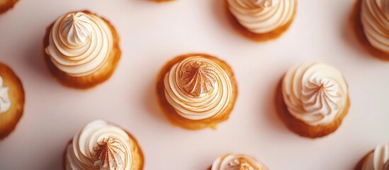 Poster - Aerial view of beautifully designed pastries with selective focus showcasing intricate frosting details and soft blurred background elements