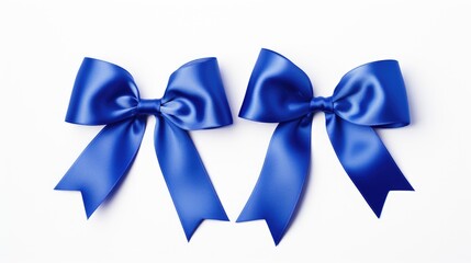 Poster - Blue satin ribbon bows elegantly arranged on a clean white background perfect for gift wrapping or decorative elements.