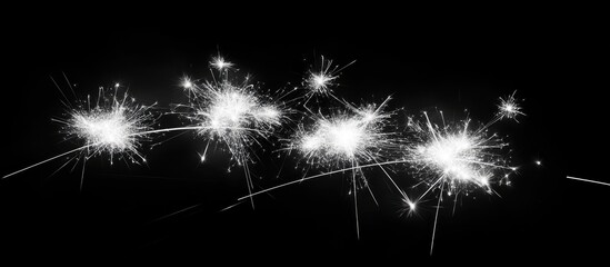 Leinwandbilder - Sparkling white fireworks illuminating a dark night sky with haze creating a dramatic and festive atmosphere for celebrations or events