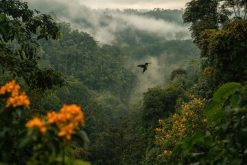 Aufkleber - A serene landscape featuring dense green forests and mist, with a bird soaring above vibrant yellow flowers in a tranquil setting.