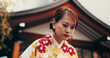 © peopleimages.com - Bow, culture and woman at temple with kimono, fashion and waiting at outdoor building with respect. Style, design and confident girl with traditional Japanese clothes, greeting and hostess at pagoda
