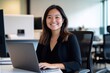 Focused young Korean female professional IT specialist business working on laptop pc sitting at desk in modern office. Smiling Asian woman using computer technology app for work.