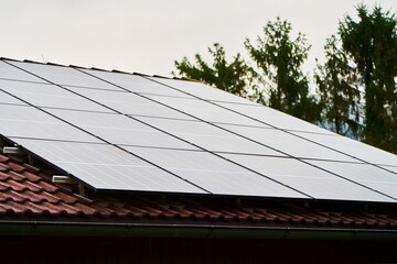 Wall Mural - Alpine Home with Solar Panels. Harnessing Sunlight for Energy