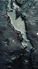 Wall Mural - dark moody abstract crack texture: water puddle on asphalt